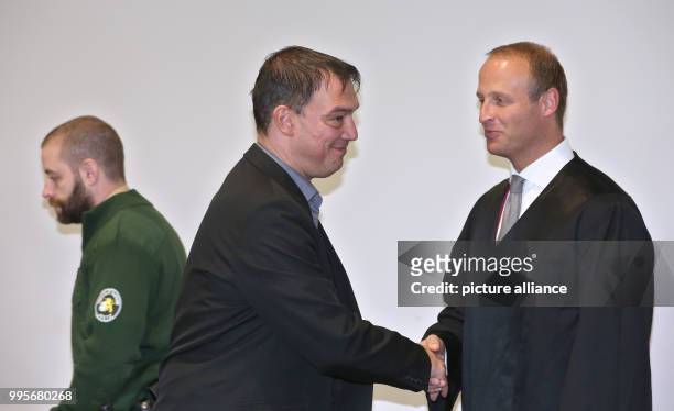 Linus Foerster greets his lawyer Hans Joerg Schmied in the court room of the district court in Augsburg, Germany, 29 September 2017. The former state...