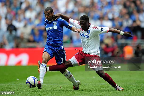 Ashley Cole of Chelsea is tackled by Aruna Dindane of Portsmouth during the FA Cup sponsored by E.ON Final match between Chelsea and Portsmouth at...