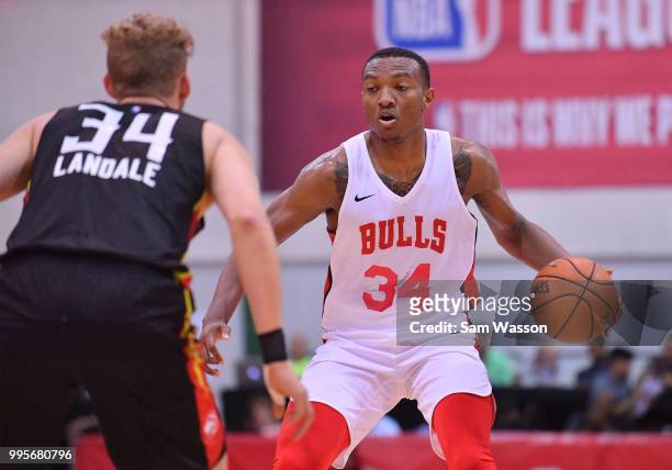 Wendell Carter Jr. #34 of the Chicago Bulls dribbles against Jock Landale of the Atlanta Hawks during the 2018 NBA Summer League at the Cox Pavilion...