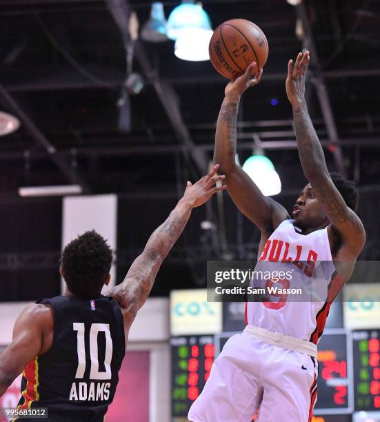 Antonio Blakeney of the Chicago Bulls shoots against Jaylen Adams of the Atlanta Hawks during the 2018 NBA Summer League at the Cox Pavilion on July...