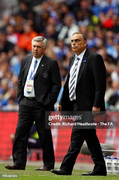 Carlo Ancelotti, manager of Chelsea, and Avram Grant, manager of Portsmouth pass instructions on to their teams during the FA Cup sponsored by E.ON...