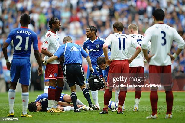 Michael Ballack of Chelsea hold his leg after being tackled and fouled by Kevin Prince Boateng of Portsmouth during the FA Cup sponsored by E.ON...