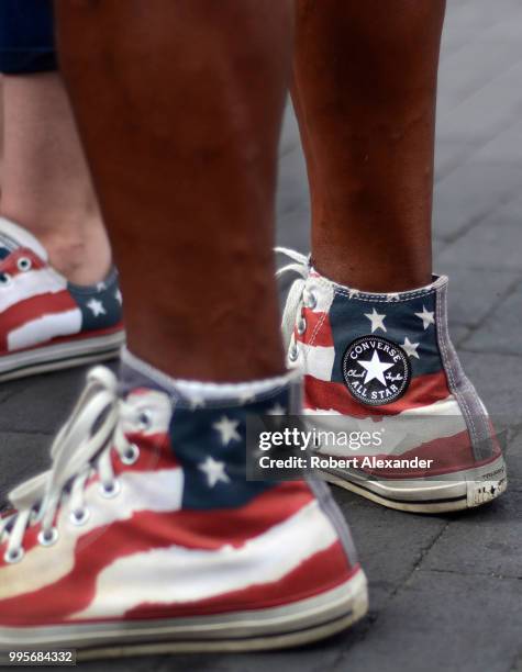 Man wears 'stars and stripes' Converse Chuck Taylor All Star high top shoes as he enjoys a Fourth of July holiday celebration in Santa Fe, New Mexico.