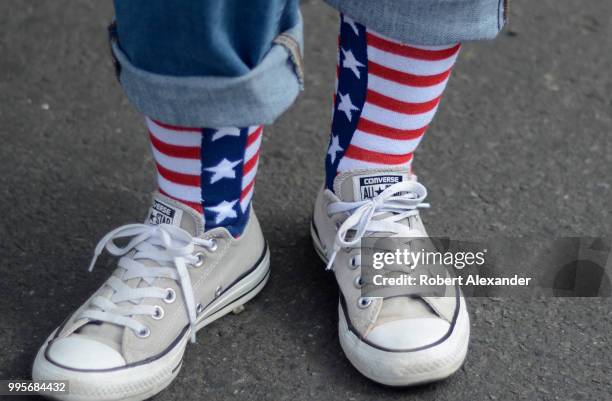 Woman wears 'stars and stripes' sock wth Converse All Star shoes as she enjoys a Fourth of July holiday celebration in Santa Fe, New Mexico.