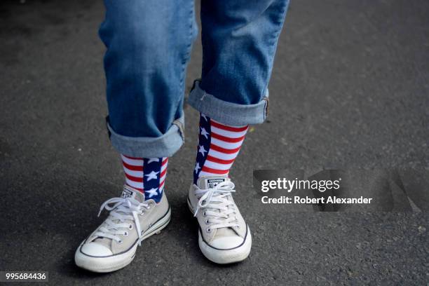 Woman wears 'stars and stripes' sock wth Converse All Star shoes as she enjoys a Fourth of July holiday celebration in Santa Fe, New Mexico.