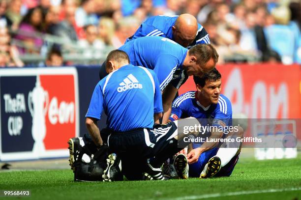 Michael Ballack of Chelsea is attended to by medical staff after being tackled and fouled by Kevin Prince Boateng of Portsmouth during the FA Cup...