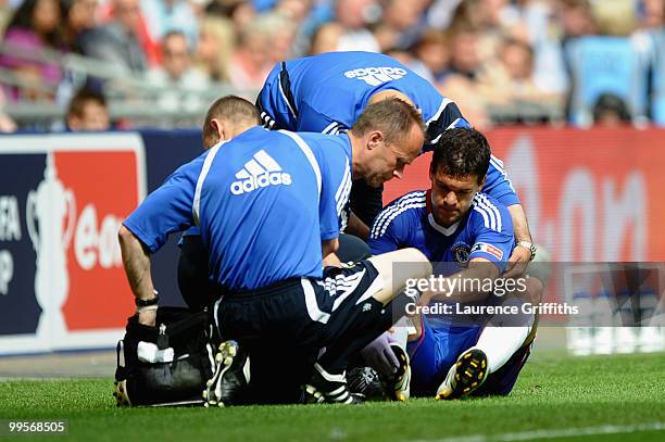 Michael Ballack of Chelsea is attended to by medical staff after being tackled and fouled by Kevin Prince Boateng of Portsmouth during the FA Cup...