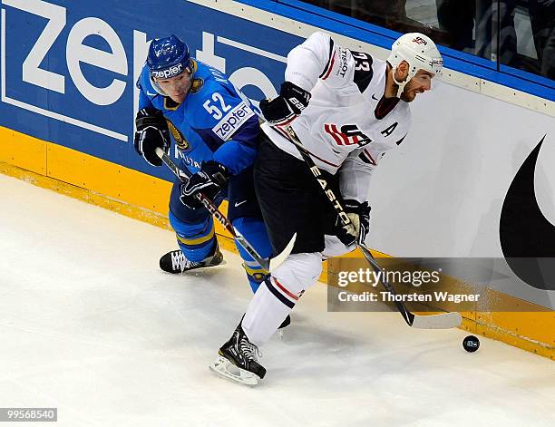 Eric Nystroem of United States battles for the puck with Alexei Koledayev of Kazakhstan during the IIHF World Championship final round match between...