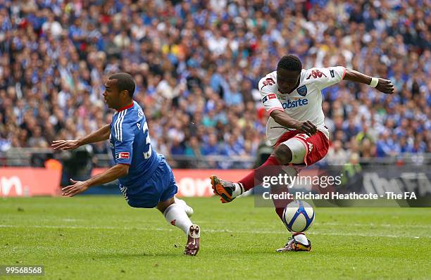 Aruna Dindane of Portsmouth misses his kick under pressure from Ashley Cole of Chelsea during the FA Cup sponsored by E.ON Final match between...