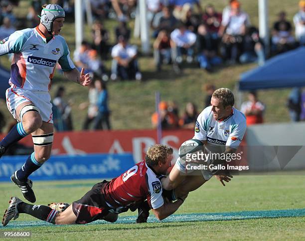 Sarel Pretorius of the Cheetahs tackled by Jano Vermaak of the Lions during the Super 14 match between Vodacom Cheetahs and Auto and General Lions...