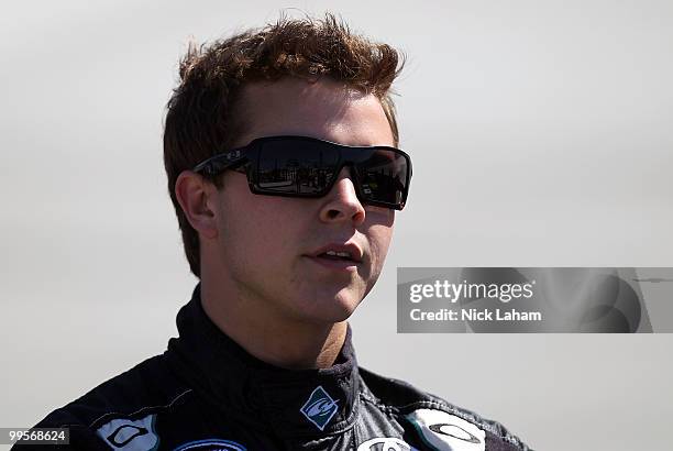 Trevor Bayne, driver of the Aaron's Dream Machine Toyota, stands on the grid during qualifying for the NASCAR Nationwide Series Heluva Good 200 at...