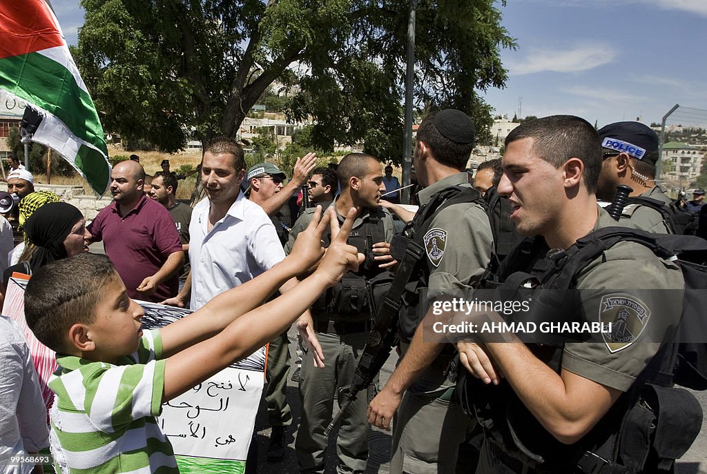 A Palestinian boy flashes the V-sign for