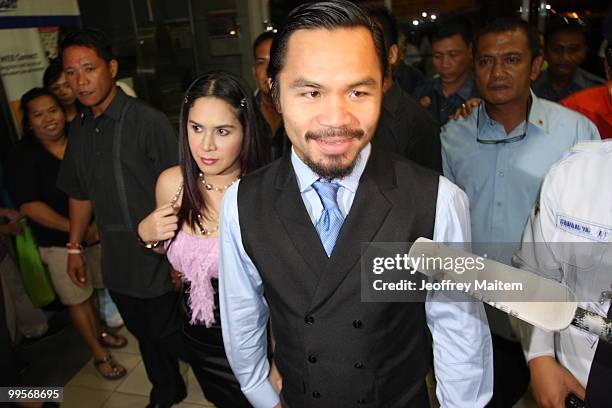 World welterweight boxing champion Manny Pacquiao and wife Jinkee Pacquiao arrive at the KCC Mall on May 15, 2010 in General Santos, Philippines....