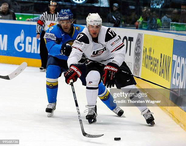 Brandon Dubinsky of United States battles for the puck with Vladimir Antipin of Kazakhstan during the IIHF World Championship final round match...