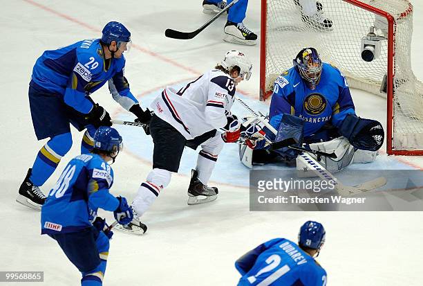 Tim Kennedy of United States battles for the puck with Alexei Vasslichenko and Alexei Kuzentsov of Kazakhstan during the IIHF World Championship...