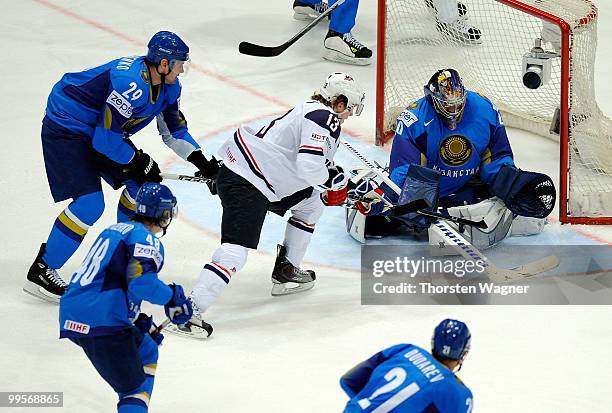 Tim Kennedy of United States battles for the puck with Alexei Vasslichenko and Alexei Kuzentsov of Kazakhstan during the IIHF World Championship...