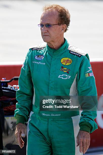 Morgan Shepherd, driver of the Racing with Jesus Chevrolet, stands on the grid during qualifying for the NASCAR Nationwide Series Heluva Good 200 at...