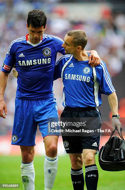 Michael Ballack of Chelsea is helped off the field following his injury during the FA Cup sponsored by E.ON Final match between Chelsea and...