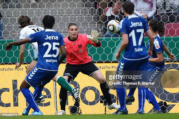 Annike Krahn of Duisburg scores against Marlyse Ngo Ndoumbouk and Jana Burmeister of Jena during the DFB Women's Cup final match between FCR 2001...