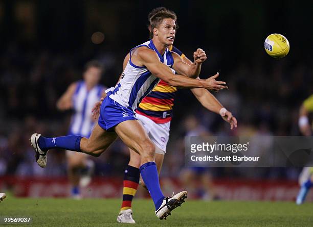 Andrew Swallow of the Kangaroos passes the ball during the round eight AFL match between the North Melbourne Kangaroos and the Adelaide Crows at...