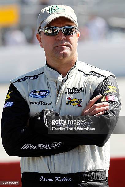 Jason Keller, driver of the TriStar Motorsports Chevrolet, stands on the grid during qualifying for the NASCAR Nationwide Series Heluva Good 200 at...