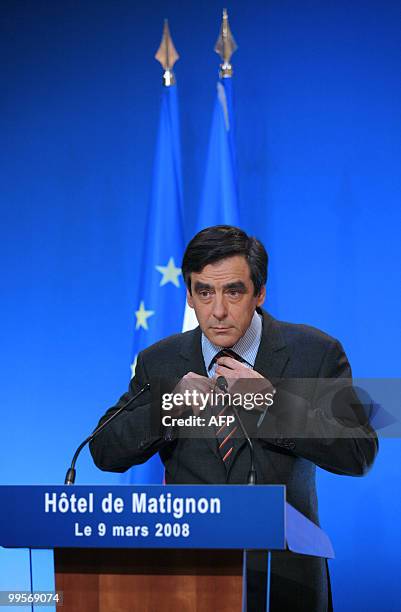 French Prime Minister Francois Fillon adjusts his tie before giving a televised speech on March 9, 2008 at the Matignon hotel in Paris. The...