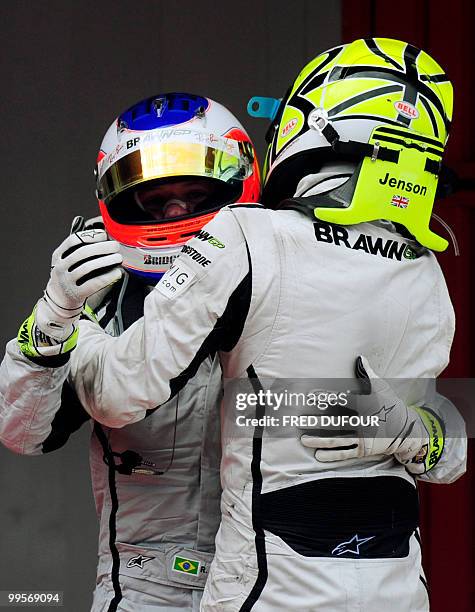 Brawn GP's British driver Jenson Button celebrates with Brawn GP's Brazilian driver Rubens Barrichello in the parc ferme of the Circuit de Catalunya,...