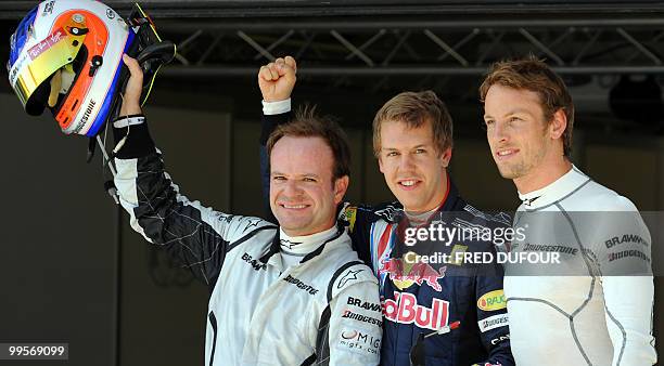 Brawn GP's Brazilian driver Rubens Barrichello, Red Bull's German driver Sebastian Vettel and Brawn GP's British driver Jenson Button pose in the...