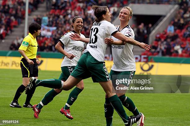 Annike Krahn of Duisburg celebrates her team's first goal with team mate Alexandra Popp and Inka Grings during the DFB Women's Cup final match...