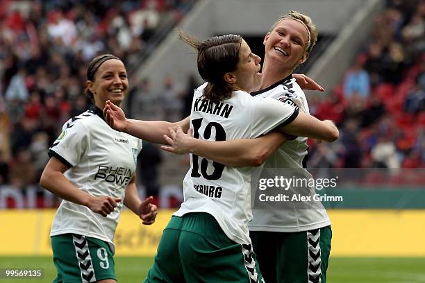 Annike Krahn of Duisburg celebrates her team's first goal with team mate Alexandra Popp and Inka Grings during the DFB Women's Cup final match...