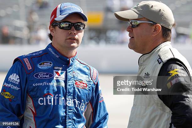 Jason Keller , driver of the TriStar Motorsports Chevrolet, talks with Ricky Stenhouse Jr., driver of the CitiFinancial Ford, during qualifying for...