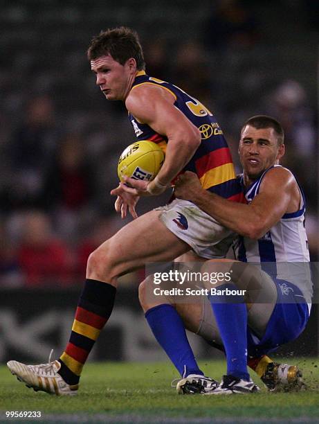 Patrick Dangerfield of the Crows is tackled by Daniel Pratt of the Kangaroos during the round eight AFL match between the North Melbourne Kangaroos...