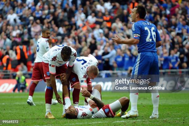 Kevin Prince Boateng of Portsmouth falls to the ground after he takes and misses a penalty during the FA Cup sponsored by E.ON Final match between...