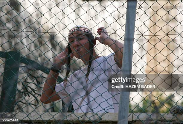 Jewish settler boy sticks his tongue out at Palestinian and foreign peace activists protesting near an Israeli army checkpoint in the occupied West...