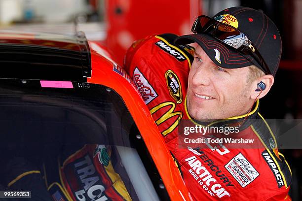 Jamie McMurray, driver of the Bass Pro Shops Chevrolet, gets into his car in the garage prior to practice for the NASCAR Sprint Cup Series Autism...