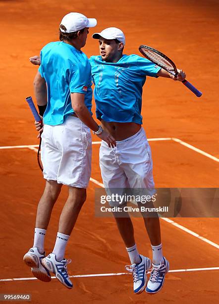 Bob Bryan and Mike Bryan of the USA celebrate match point against Marcel Granollers of Spain and Viktor Troicki of Serbia in their semi final doubles...