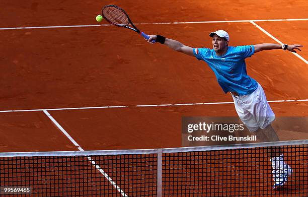 Mike Bryan of the USA volleys at the net against Marcel Granollers of Spain and Viktor Troicki of Serbia in their semi final doubles match during the...