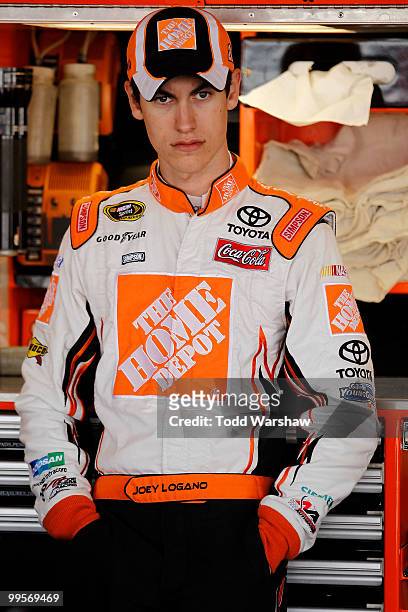 Joey Logano , driver of the The Home Depot Toyota, stands in the garage prior to practice for the NASCAR Sprint Cup Series Autism Speaks 400 at Dover...