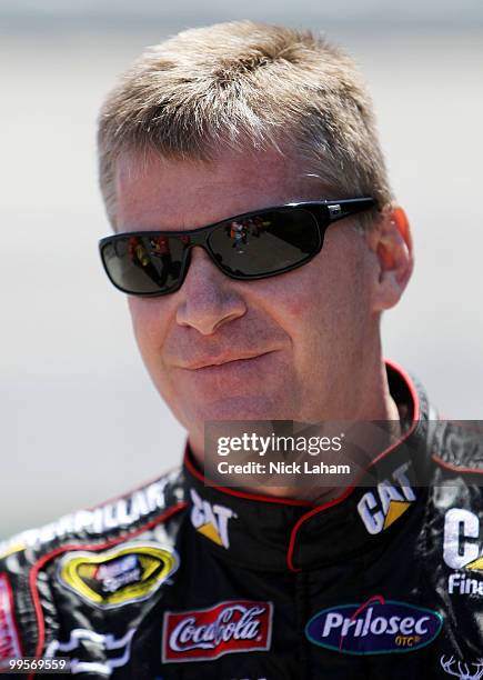 Jeff Burton, driver of the Caterpillar Chevrolet, walks in the garage area during practice for the NASCAR Sprint Cup Series Autism Speaks 400 at...