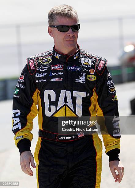 Jeff Burton, driver of the Caterpillar Chevrolet, walks in the garage area during practice for the NASCAR Sprint Cup Series Autism Speaks 400 at...