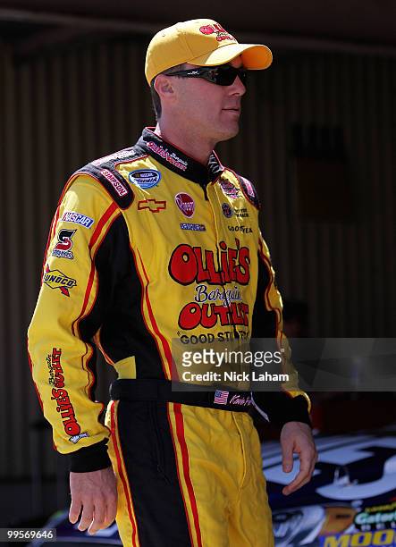 Kevin Harvick, driver of the Shell/Pennzoil Chevrolet, walks in the garage area during practice for the NASCAR Sprint Cup Series Autism Speaks 400 at...