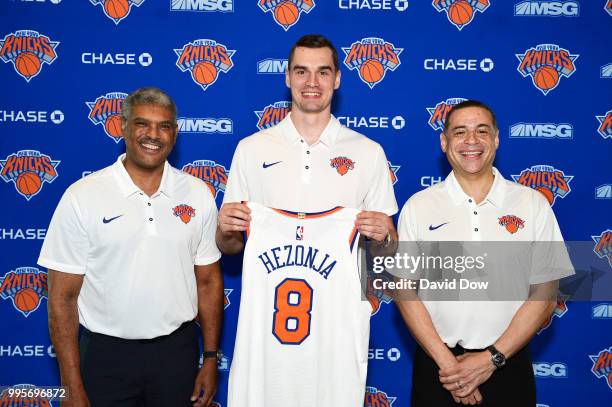 President Steve Mills, Mario Hezonja, and General Manager Scott Perry of the New York Knicks poses for a photo announcing Mario's signing on July 10,...