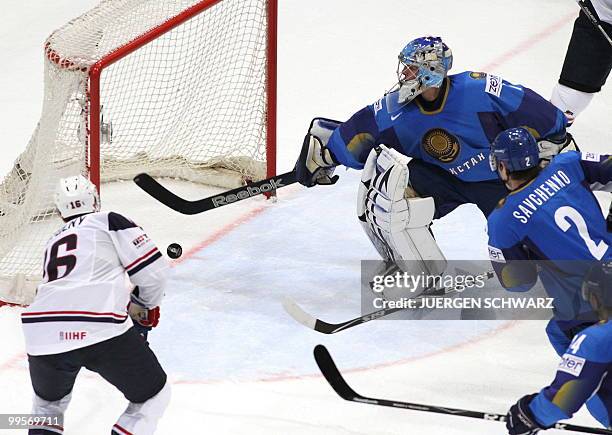 S Ryan Potulny scores past Kazakhstan's goalkeeper Vitali Yeremeyev and Roman Savchenko during the IIHF Ice Hockey World Championship match USA vs...