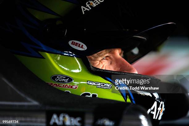 Carl Edwards, driver of the Aflac Ford, sits in his car in the garag during practice for the NASCAR Sprint Cup Series Autism Speaks 400 at Dover...