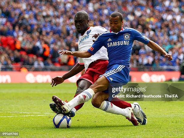 Ashley Cole of Chelsea is challenged by Papa Bouba Diop of Portsmouth during the FA Cup sponsored by E.ON Final match between Chelsea and Portsmouth...