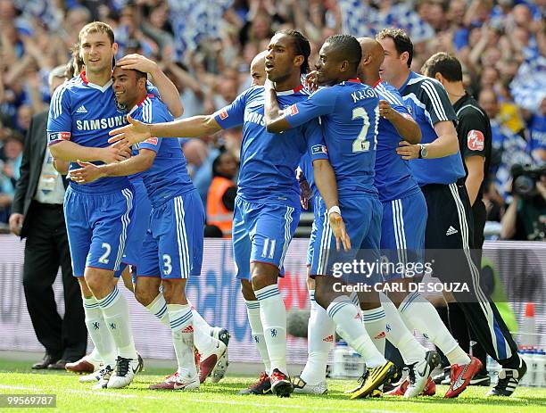 Chelsea's Ivorian striker Didier Drogba celebrates with team-mates after scoring his team's first goal against Portsmouth defence during the FA Cup...