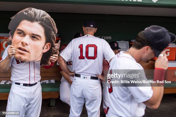 Brock Holt of the Boston Red Sox reacts with a big head cut out of Andrew Benintendi before a game against the Texas Rangers on July 10, 2018 at...