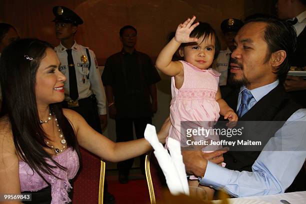 World welterweight boxing champion Manny Pacquiao is seen with his daughter Queen Pacquiao and wife Jinkee Pacquiao at the KCC Mall on May 15, 2010...
