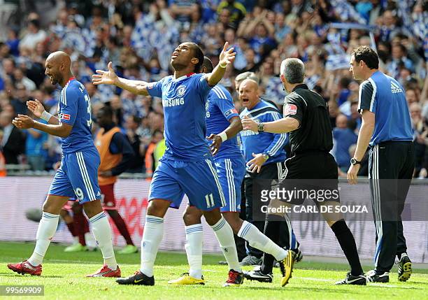 Chelsea's Ivorian striker Didier Drogba celebrates with team-mates after scoring his team's first goal against Portsmouth defence during the FA Cup...