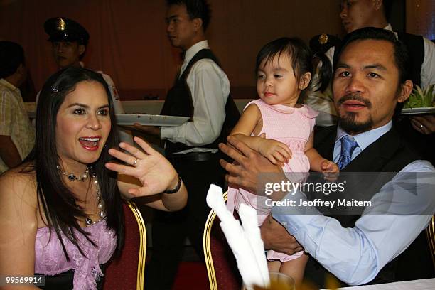 World welterweight boxing champion Manny Pacquiao is seen with his daughter Queen Pacquiao and wife Jinkee Pacquiao at the KCC Mall on May 15, 2010...